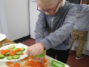 Boy cutting carrots