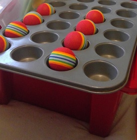 Coloured balls in a baking tray - homemade toys